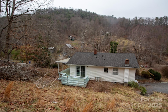 rear view of house featuring a deck