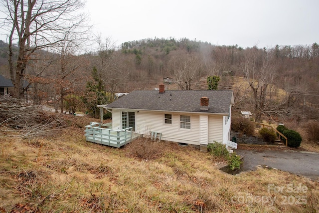 back of house with a deck