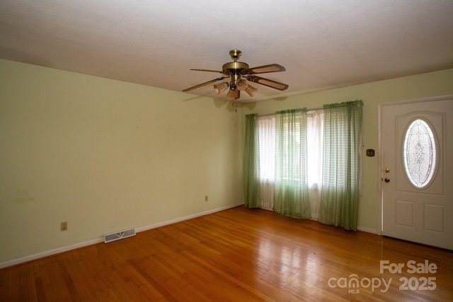 foyer entrance with hardwood / wood-style flooring and ceiling fan