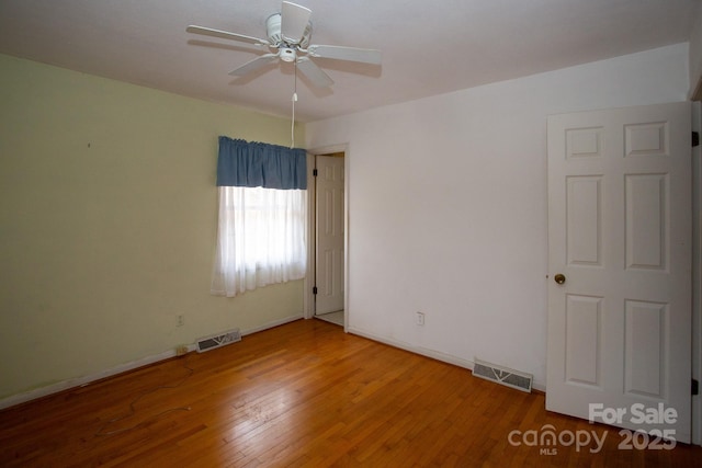 empty room featuring hardwood / wood-style flooring and ceiling fan