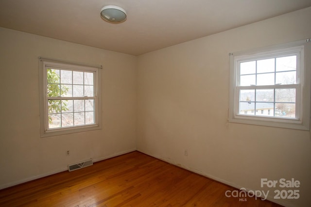 unfurnished room with light wood-type flooring