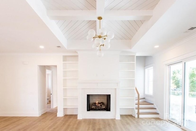 unfurnished living room with beamed ceiling, built in shelves, and light wood-type flooring