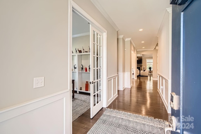 corridor featuring french doors, dark hardwood / wood-style floors, and ornamental molding