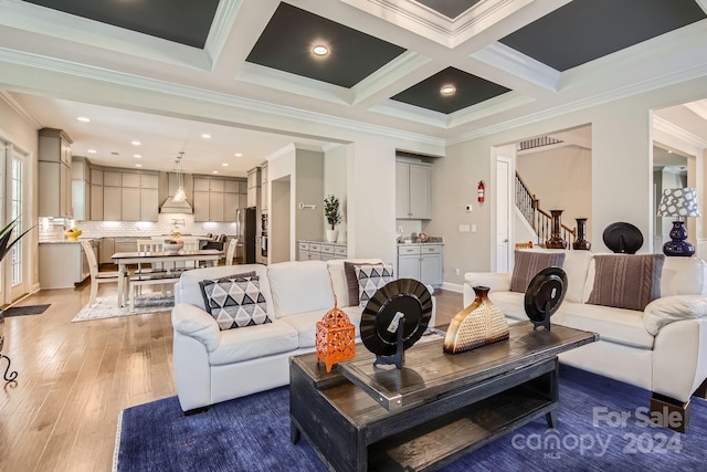 living room with beamed ceiling, light hardwood / wood-style floors, crown molding, and coffered ceiling