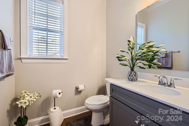 bathroom featuring vanity and toilet