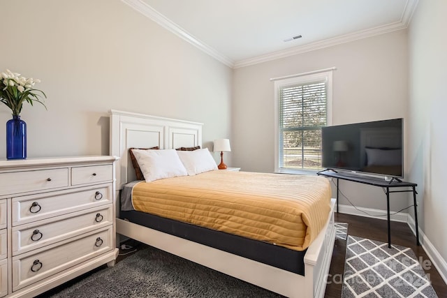 bedroom featuring crown molding and dark hardwood / wood-style flooring