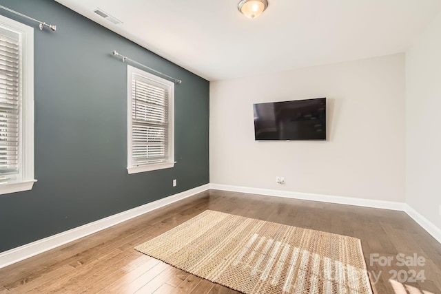 spare room with hardwood / wood-style flooring