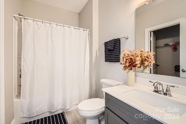 bathroom with walk in shower, vanity, and toilet