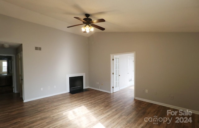 empty room with vaulted ceiling, ceiling fan, and dark wood-type flooring