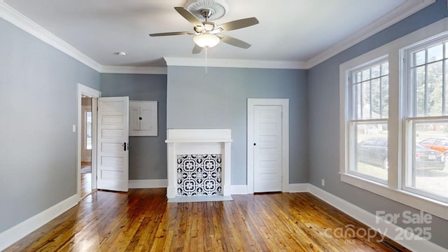 unfurnished living room with dark hardwood / wood-style floors, ceiling fan, and ornamental molding