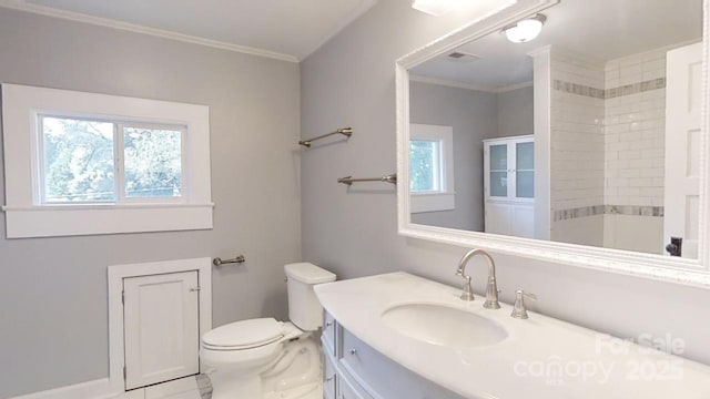 bathroom featuring crown molding, vanity, and toilet