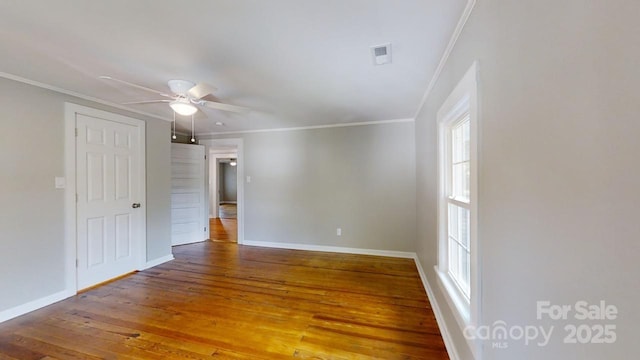 unfurnished room featuring ceiling fan, wood-type flooring, and ornamental molding