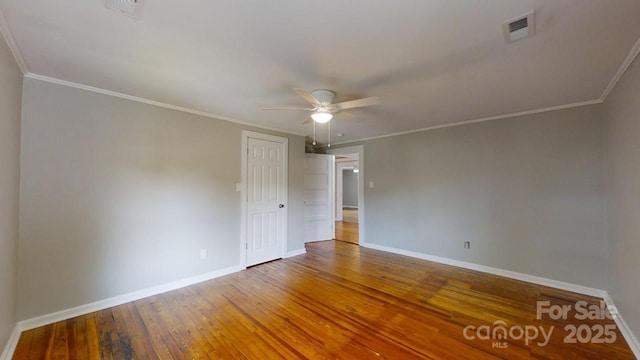 spare room with hardwood / wood-style floors, ceiling fan, and crown molding