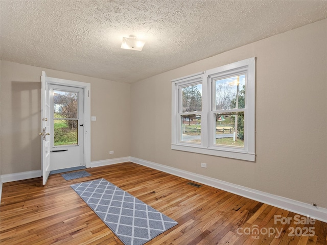 interior space with hardwood / wood-style flooring and a textured ceiling