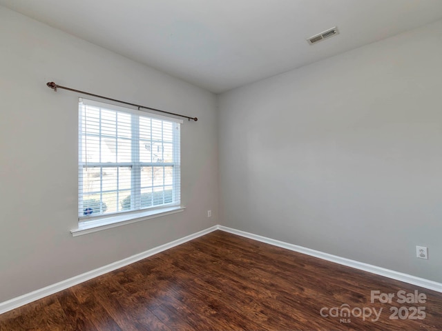 empty room featuring dark hardwood / wood-style floors