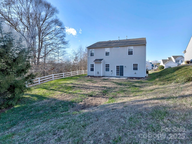 back of house featuring a yard