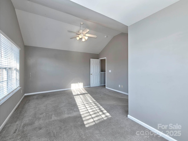 spare room featuring carpet, ceiling fan, and lofted ceiling