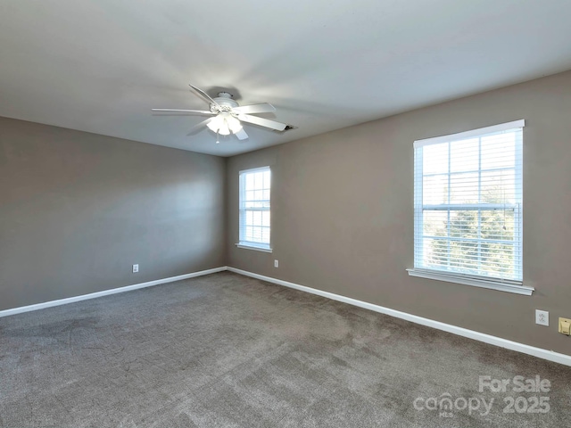 empty room with carpet flooring, ceiling fan, and plenty of natural light