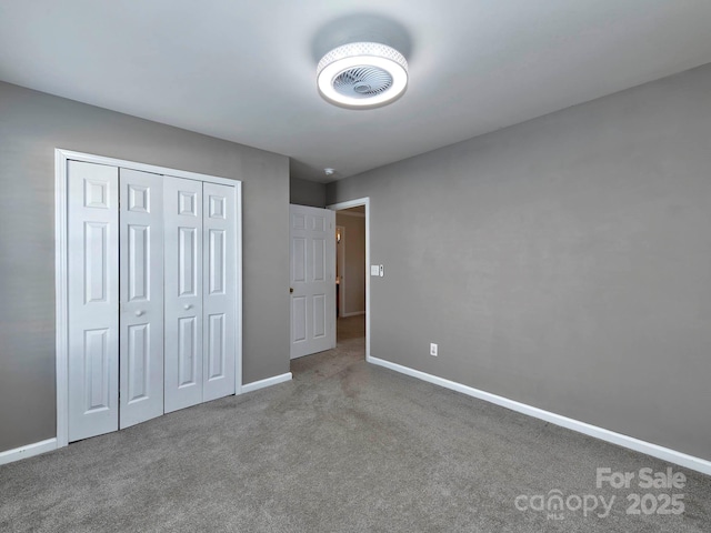 unfurnished bedroom with carpet floors and a closet