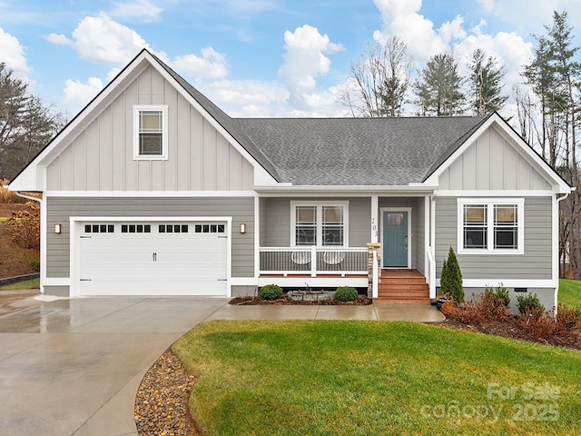 view of front facade with a porch, a garage, and a front lawn