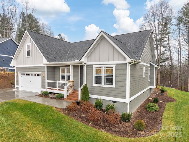 craftsman house with a garage, covered porch, and a front lawn