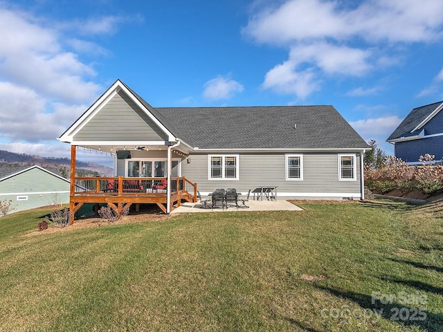 rear view of property featuring a patio area, ceiling fan, a yard, and a deck