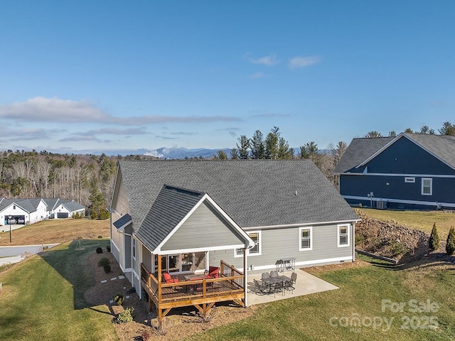 back of house with a patio area, a yard, and a deck