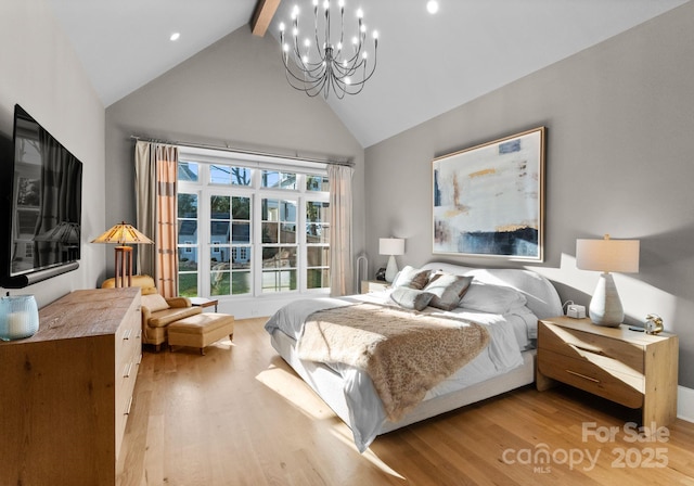 bedroom with lofted ceiling with beams, light hardwood / wood-style floors, and an inviting chandelier