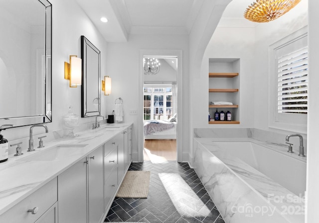 bathroom with vanity, crown molding, tile patterned flooring, built in features, and tiled bath