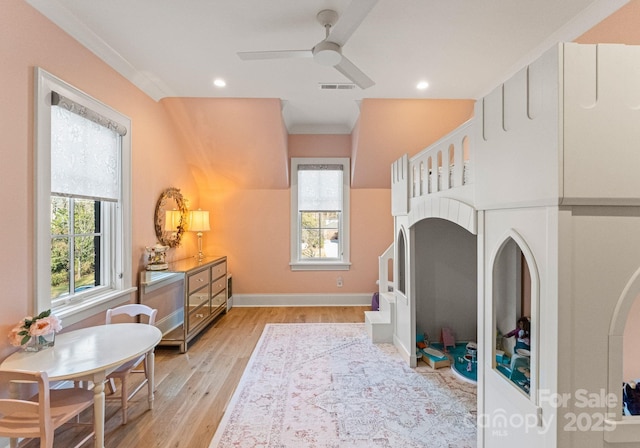 bedroom with ceiling fan, light hardwood / wood-style floors, and ornamental molding