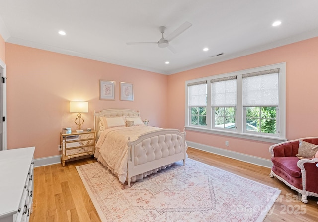 bedroom featuring light wood-type flooring, ceiling fan, and ornamental molding