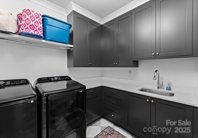 laundry room with separate washer and dryer, sink, and cabinets