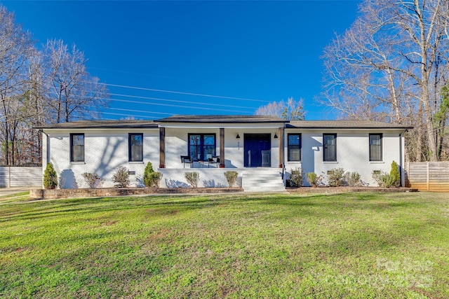 ranch-style house with covered porch and a front lawn