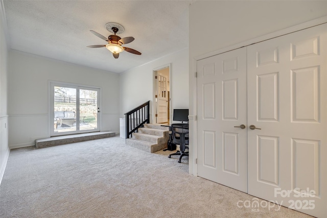 interior space featuring ceiling fan, a closet, and a textured ceiling