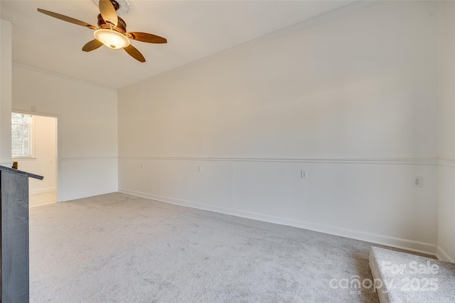 spare room with light colored carpet and ceiling fan