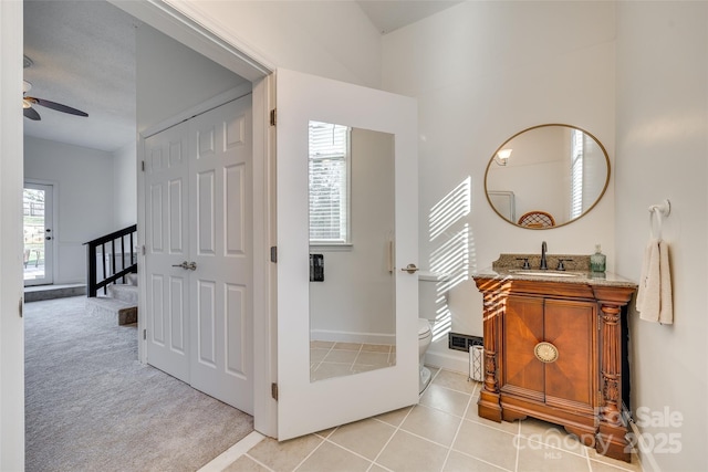 bathroom with tile patterned flooring, ceiling fan, a healthy amount of sunlight, and toilet