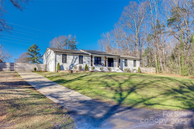 ranch-style house with covered porch and a front yard