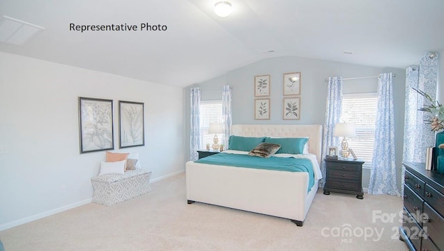 bedroom featuring light carpet, vaulted ceiling, and multiple windows