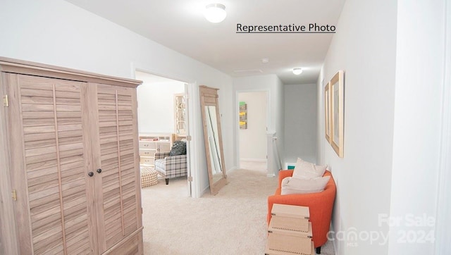 hallway featuring light colored carpet