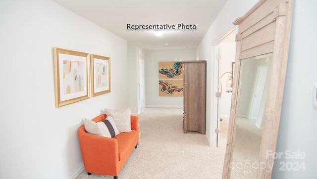 hall featuring light colored carpet