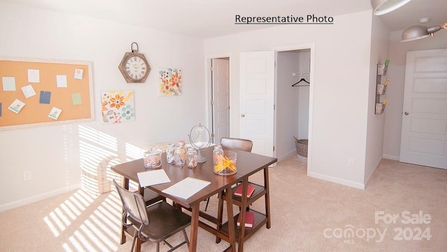 dining room with light colored carpet