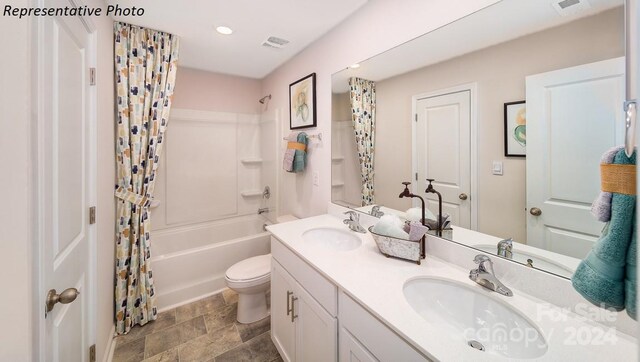 full bathroom with shower / bath combo, vanity, and toilet