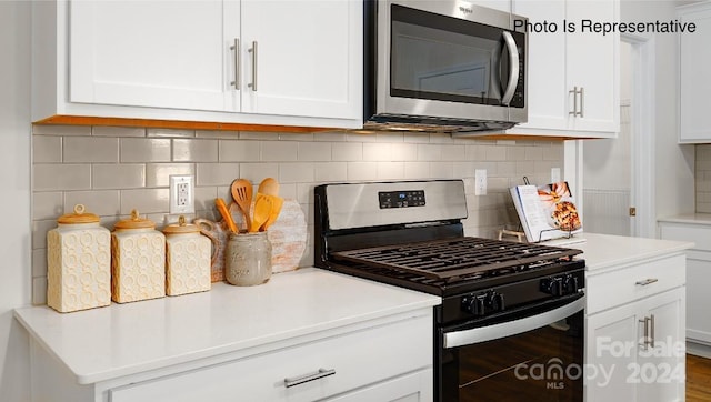 kitchen featuring stainless steel appliances and white cabinetry