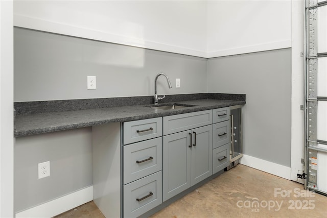 kitchen featuring gray cabinets and sink