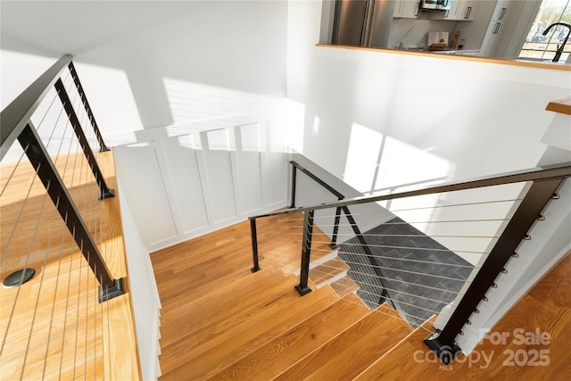 stairway with hardwood / wood-style flooring