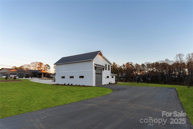 view of side of home with a garage and a yard