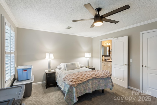 carpeted bedroom featuring ceiling fan, ornamental molding, a textured ceiling, and connected bathroom