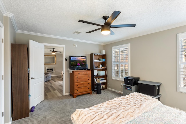 carpeted bedroom featuring a textured ceiling, ceiling fan, and ornamental molding