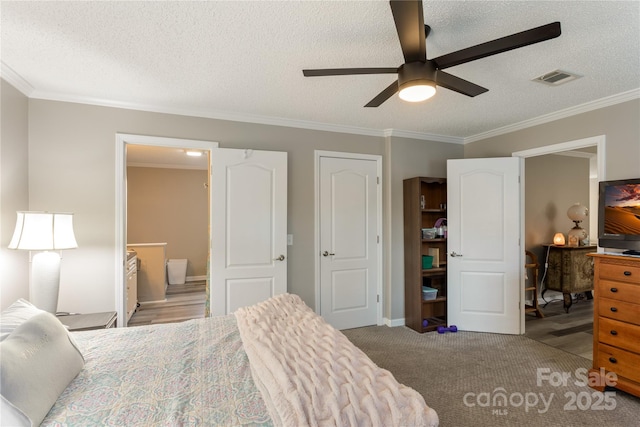 carpeted bedroom featuring a textured ceiling, ensuite bathroom, ceiling fan, and ornamental molding