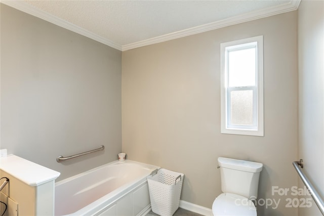 bathroom with a bathing tub, toilet, and ornamental molding